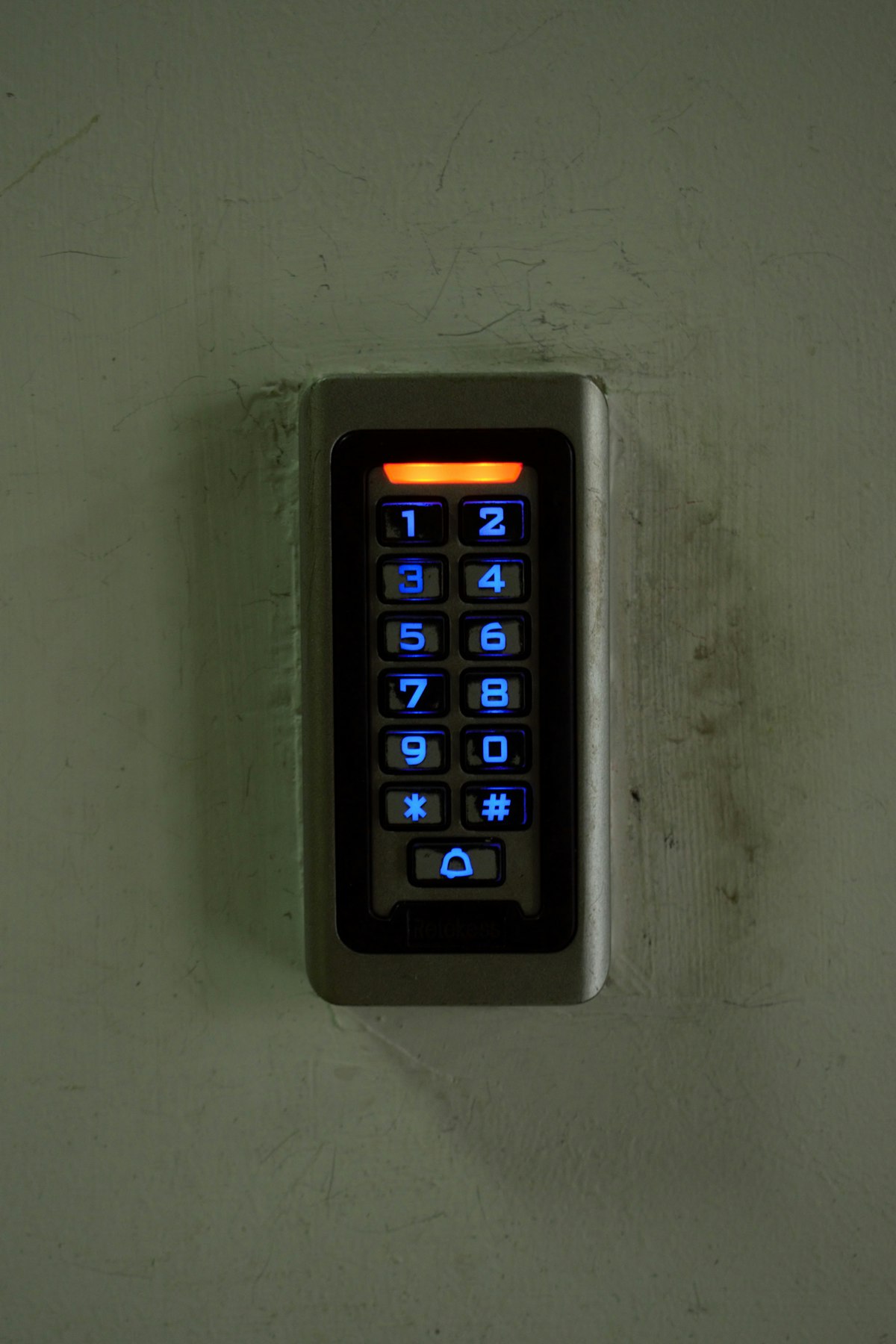 Teclado de control de acceso instalado en pared